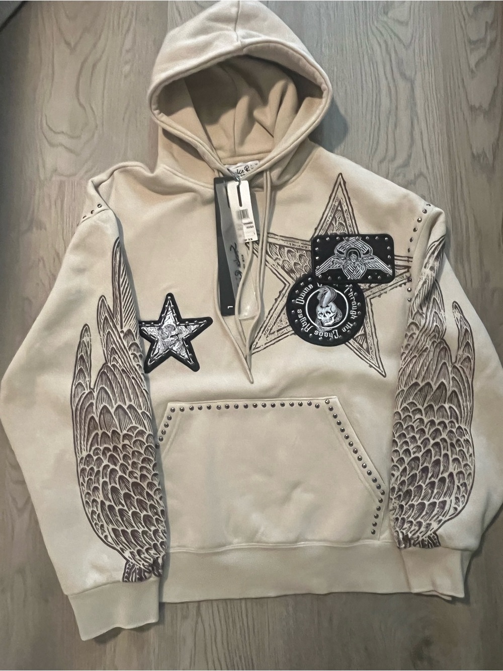 Smoke Rise Beige Graphic Studded Hoodie Sweatshirt with Wing and Star Motifs